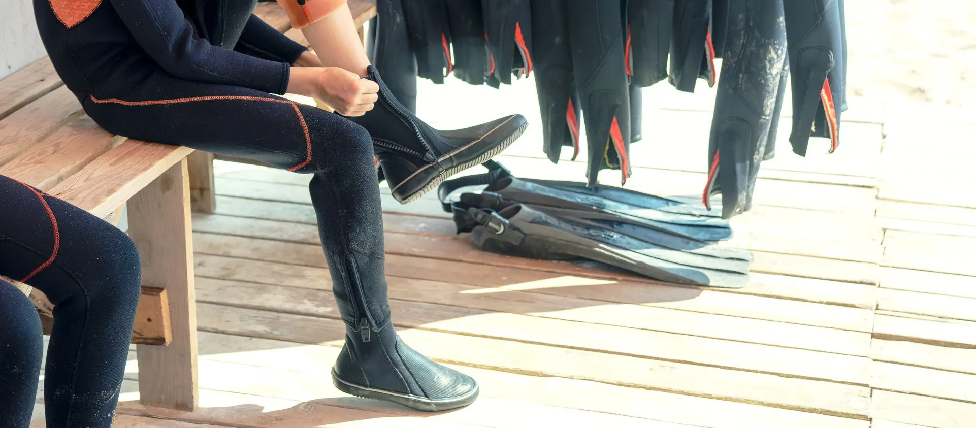boy tries on scuba boot – Dive Pro Career